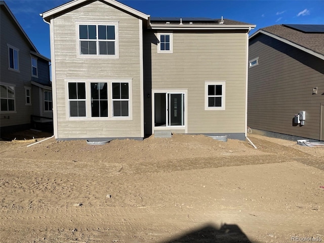 back of house with solar panels