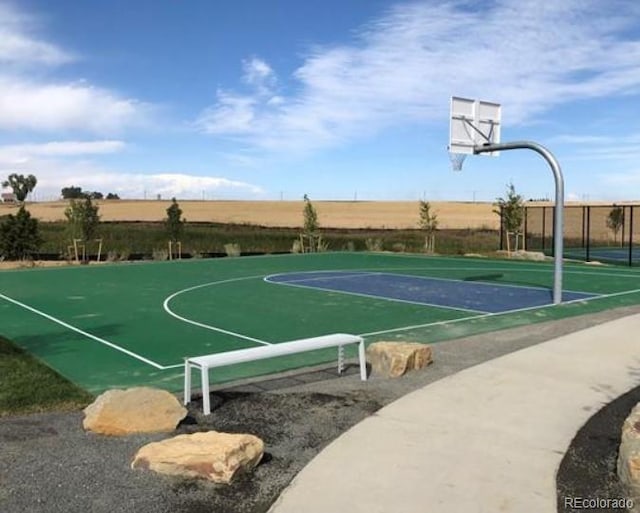 view of basketball court with community basketball court and fence