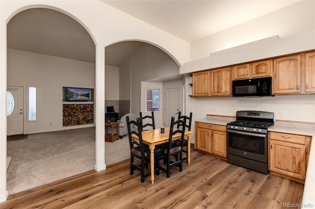 kitchen with a wealth of natural light, stainless steel range with gas cooktop, and light wood-type flooring