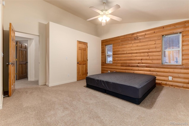 carpeted bedroom with log walls, vaulted ceiling, and ceiling fan