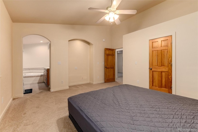 bedroom featuring ensuite bath, light colored carpet, and ceiling fan