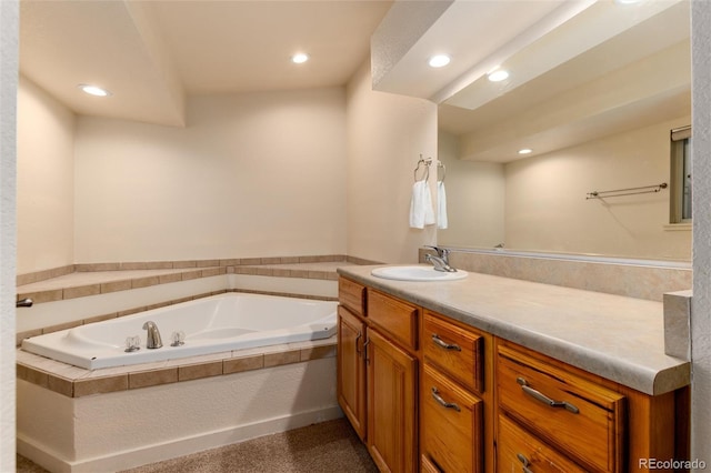 bathroom featuring vanity and tiled tub