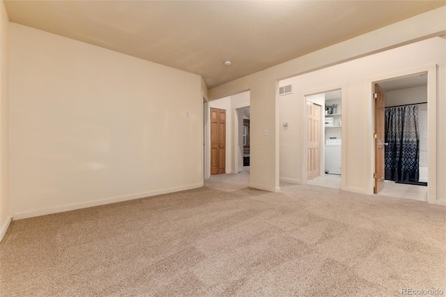 carpeted empty room with washer / clothes dryer