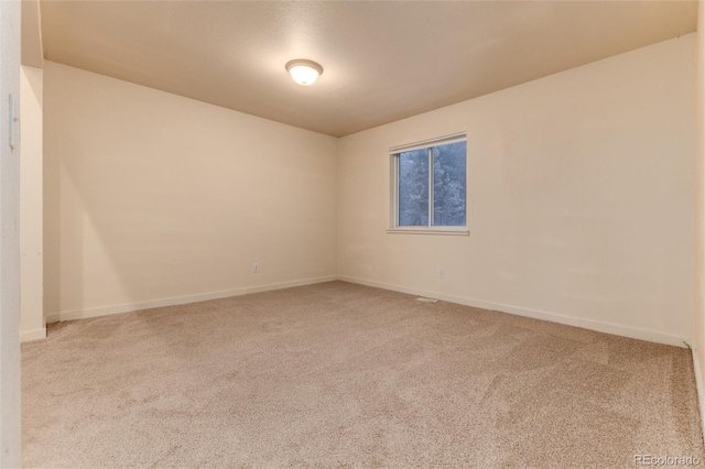 spare room with light carpet