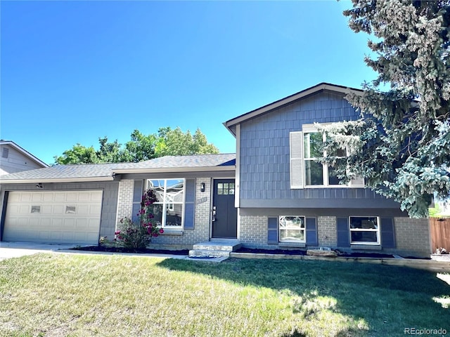 4382 S Xenon St, Morrison, CO 80465 - tri-level home with brick siding, a front yard, and a garage