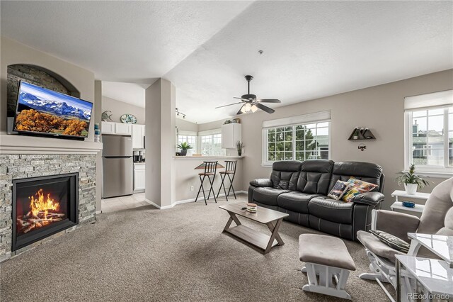 6840 Xavier Cir Unit 5, Westminster, CO 80030 - living area featuring light colored carpet, plenty of natural light, a ceiling fan, vaulted ceiling, and baseboards