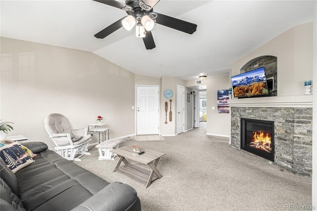 6840 Xavier Cir Unit 5, Westminster, CO 80030 - living room featuring lofted ceiling, ceiling fan, carpet, a stone fireplace, and baseboards