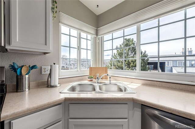 6840 Xavier Cir Unit 5, Westminster, CO 80030 - kitchen featuring a sink, dishwasher, light countertops, and vaulted ceiling