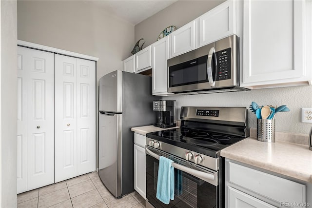 6840 Xavier Cir Unit 5, Westminster, CO 80030 - kitchen with appliances with stainless steel finishes, white cabinets, light countertops, and light tile patterned flooring