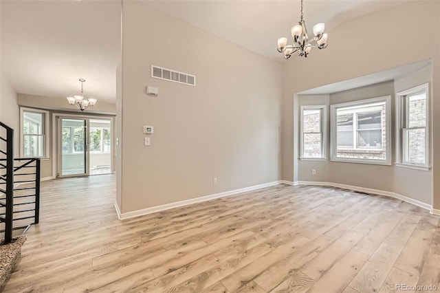 2552 E 126th Way, Thornton, CO 80241 - spare room with a chandelier, light wood finished floors, baseboards, and high vaulted ceiling