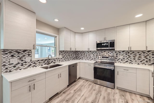 2552 E 126th Way, Thornton, CO 80241 - kitchen featuring stainless steel appliances, a sink, light countertops, backsplash, and recessed lighting