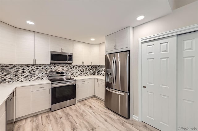 2552 E 126th Way, Thornton, CO 80241 - kitchen with stainless steel appliances, light countertops, decorative backsplash, light wood-style floors, and recessed lighting