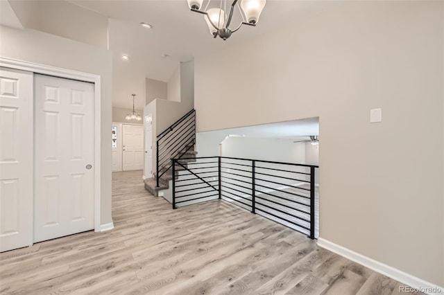2552 E 126th Way, Thornton, CO 80241 - staircase with a chandelier, wood finished floors, a ceiling fan, and baseboards