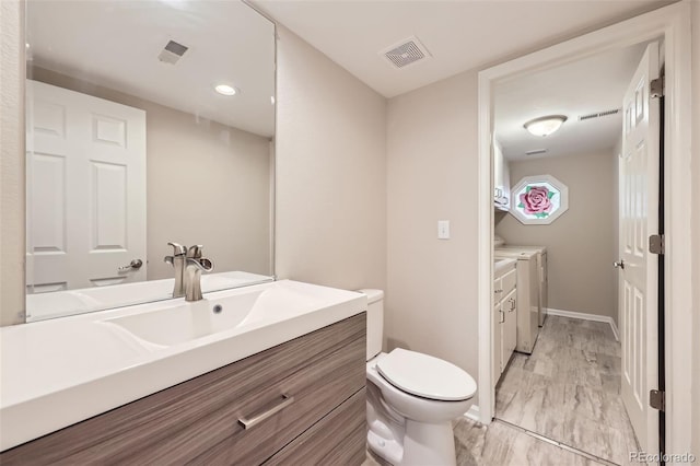 2552 E 126th Way, Thornton, CO 80241 - bathroom featuring washer and dryer, vanity, toilet, and baseboards