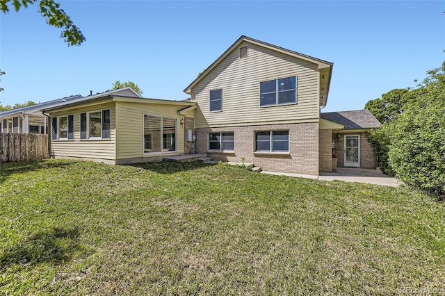 2552 E 126th Way, Thornton, CO 80241 - back of house with brick siding and a patio
