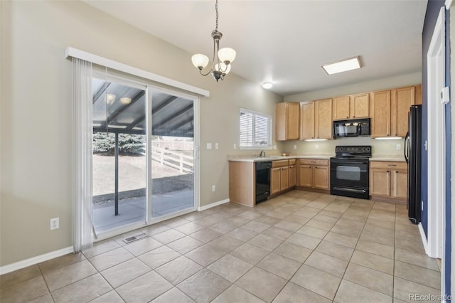 kitchen with visible vents, baseboards, black appliances, light countertops, and decorative light fixtures