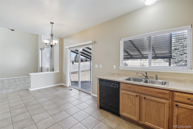 kitchen featuring dishwasher, light countertops, light tile patterned flooring, hanging light fixtures, and a sink