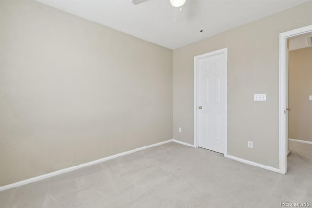 unfurnished bedroom with a ceiling fan, baseboards, and light carpet