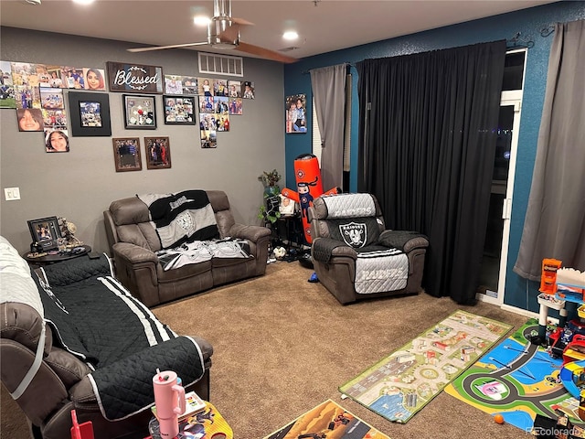 playroom with ceiling fan and carpet flooring