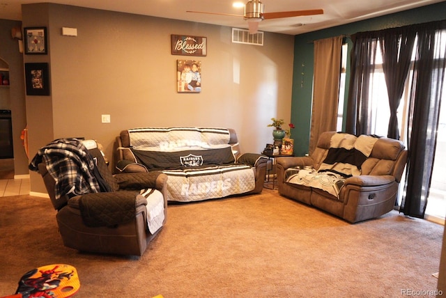 carpeted living room with visible vents and a ceiling fan