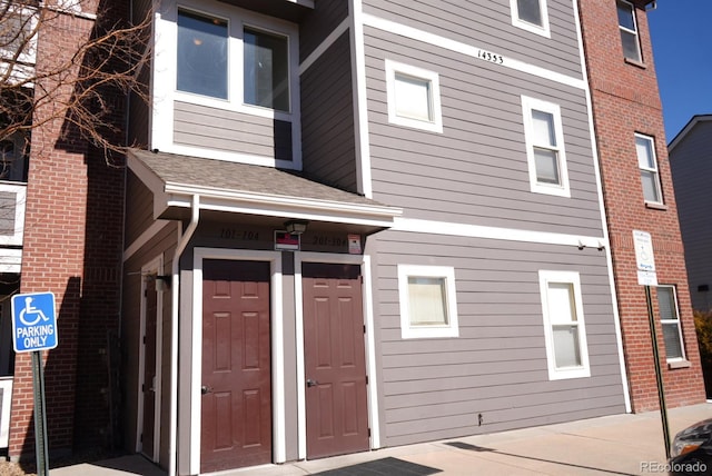 entrance to property featuring brick siding