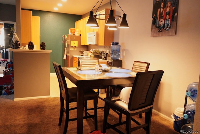 dining area with carpet flooring and baseboards