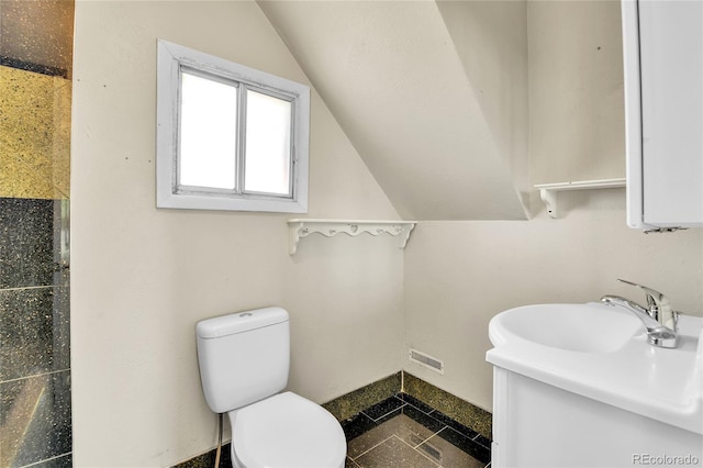 6671 Grove St, Denver, CO 80221 - bathroom featuring lofted ceiling, toilet, a sink, and granite tiled floors