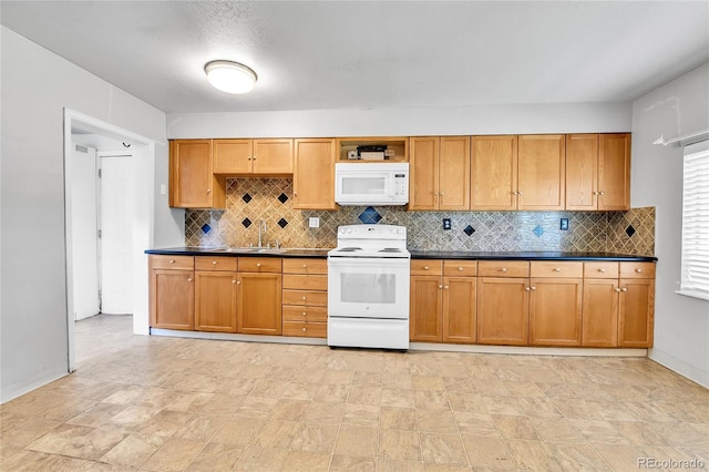 6671 Grove St, Denver, CO 80221 - kitchen featuring white appliances, tasteful backsplash, dark countertops, a sink, and brown cabinetry
