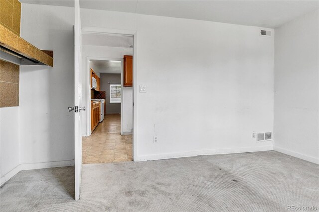 6671 Grove St, Denver, CO 80221 - spare room featuring light carpet and baseboards