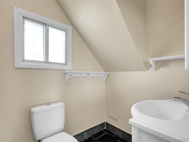6671 Grove St, Denver, CO 80221 - half bathroom featuring lofted ceiling and vanity