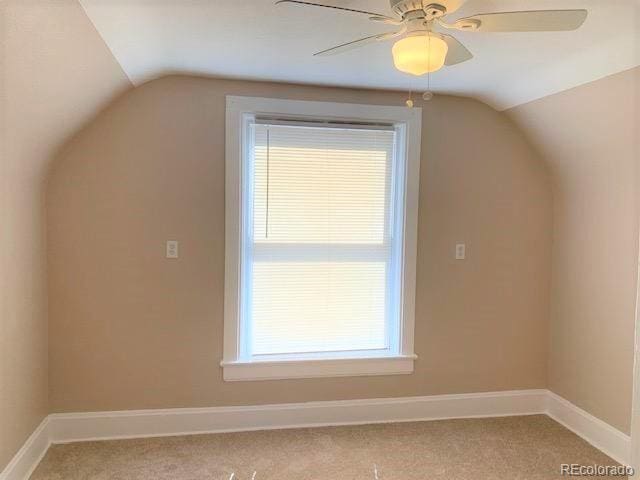 bonus room with ceiling fan, light colored carpet, and vaulted ceiling