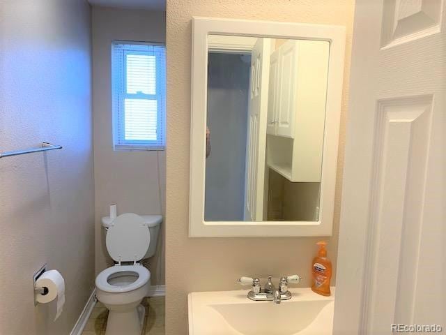 bathroom with toilet and sink