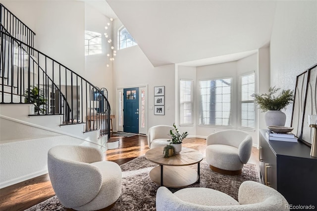 living room with high vaulted ceiling and hardwood / wood-style floors