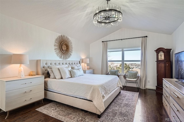 bedroom featuring dark hardwood / wood-style flooring, vaulted ceiling, and a notable chandelier