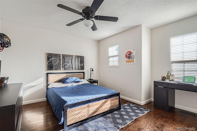 bedroom featuring a textured ceiling, ceiling fan, and dark hardwood / wood-style floors