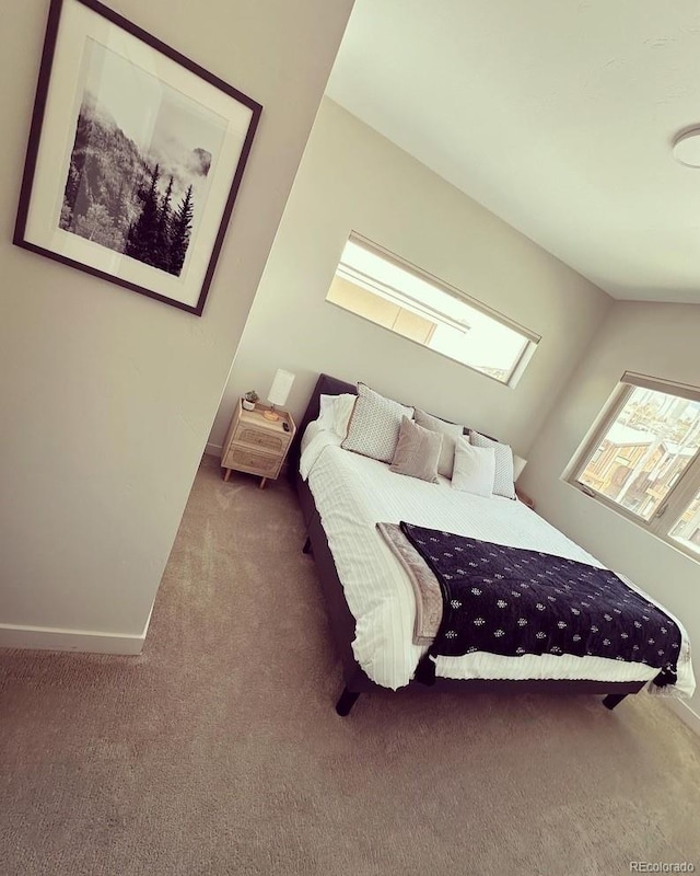 bedroom featuring carpet and lofted ceiling