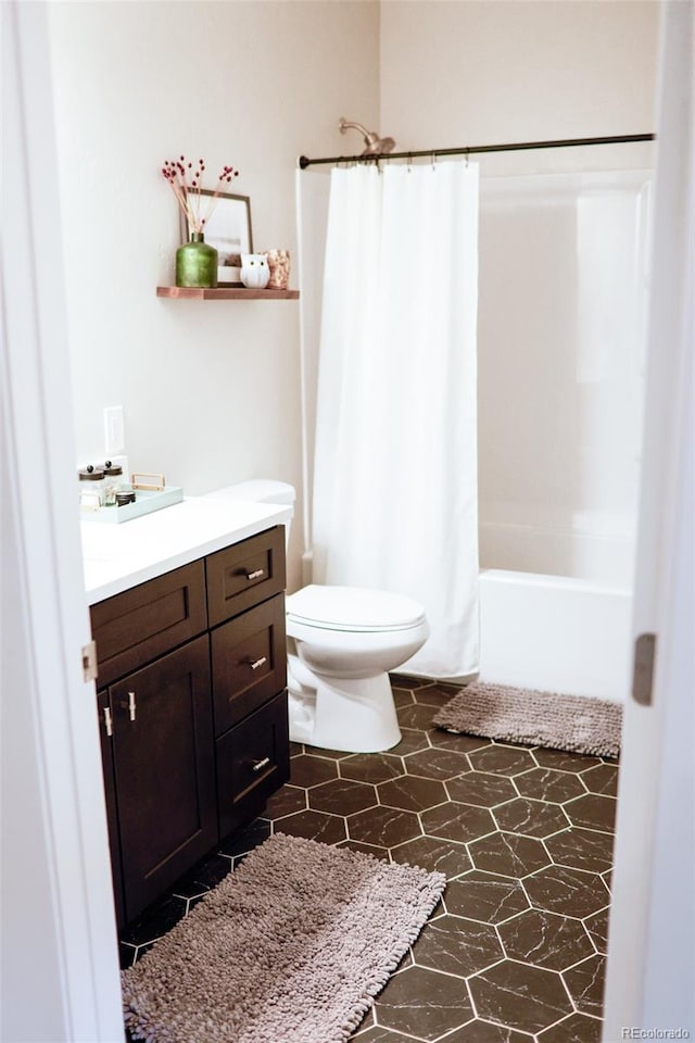 full bathroom featuring tile patterned flooring, vanity, toilet, and shower / bathtub combination with curtain