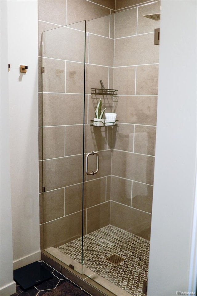 bathroom with tile patterned floors and walk in shower