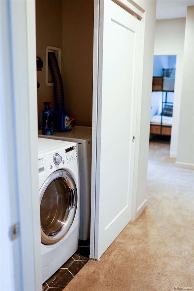 laundry room featuring carpet and independent washer and dryer