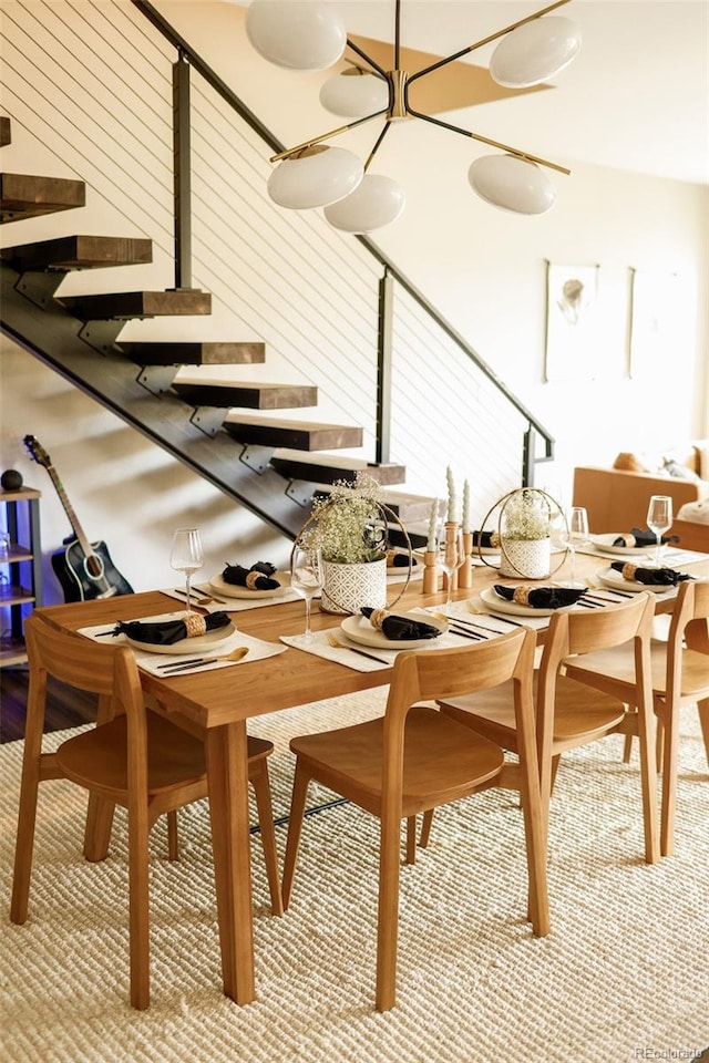 carpeted dining room with wooden walls