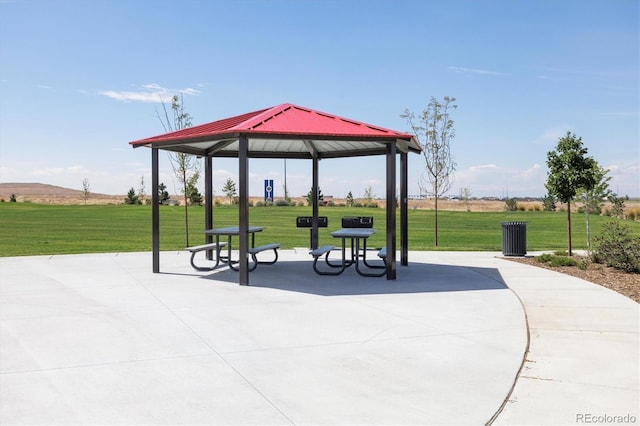 view of community with a yard, a gazebo, and a patio area