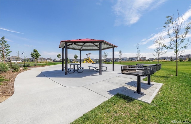 view of community with a lawn, a residential view, and playground community
