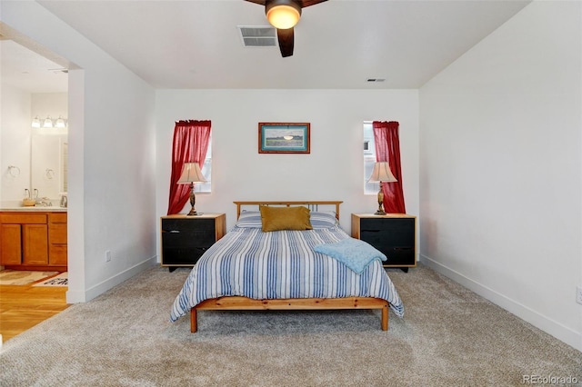 carpeted bedroom featuring ceiling fan and ensuite bathroom