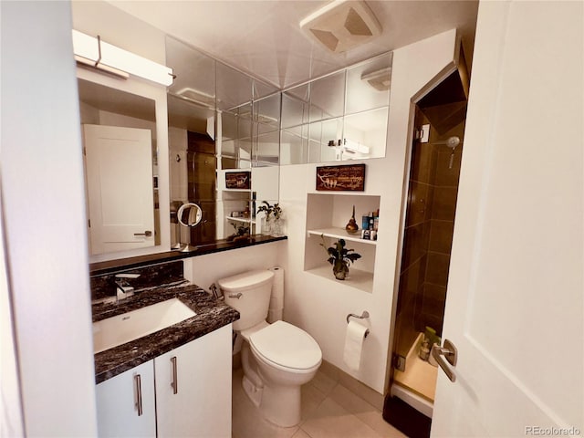 bathroom featuring oversized vanity, toilet, and tile floors