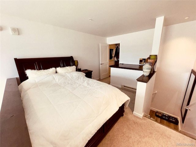 carpeted bedroom featuring a baseboard heating unit