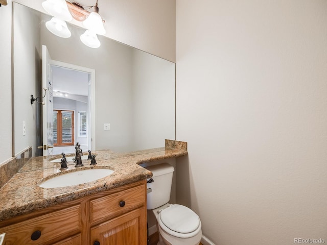 bathroom featuring vanity and toilet