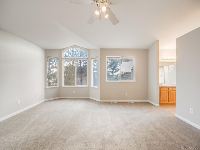 spare room featuring ceiling fan and light carpet