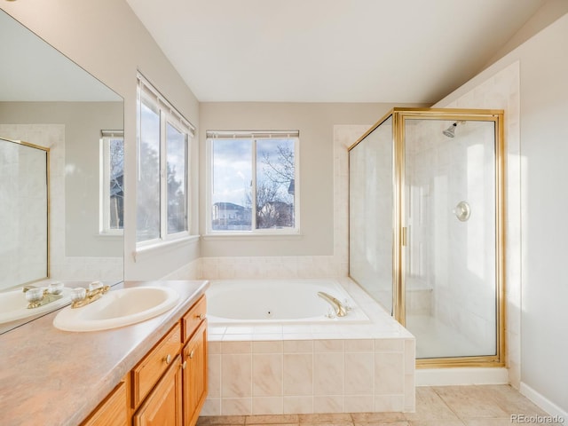 bathroom featuring vanity, tile patterned flooring, and separate shower and tub