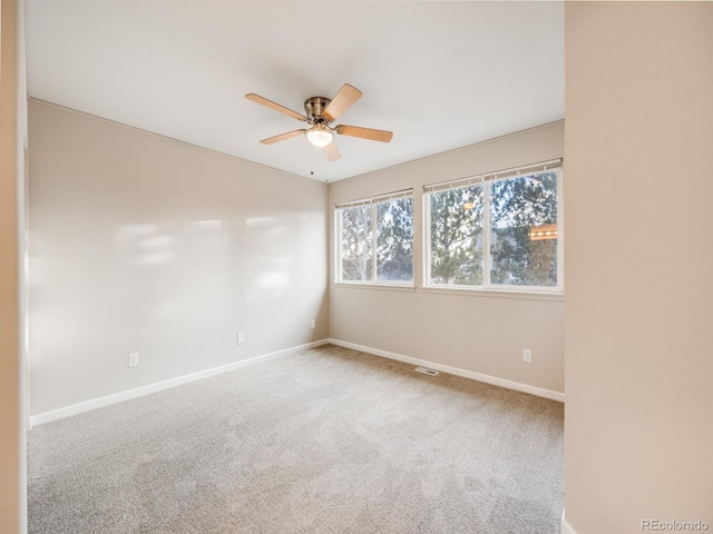 spare room with carpet floors and ceiling fan