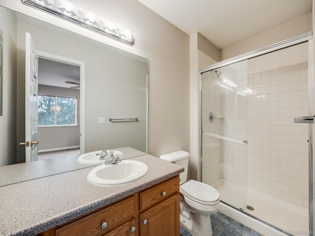 bathroom featuring vanity, toilet, and an enclosed shower